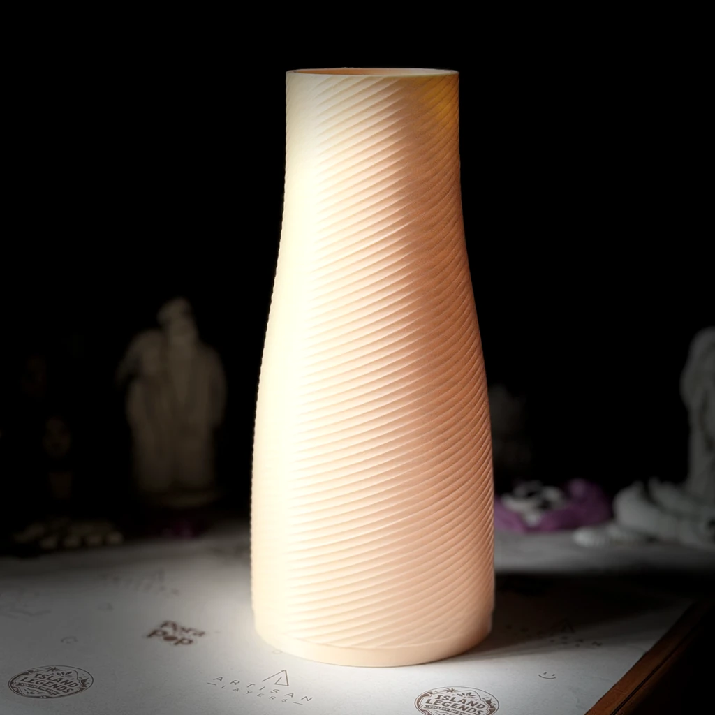 A tall spiral-textured vase glowing in warm light