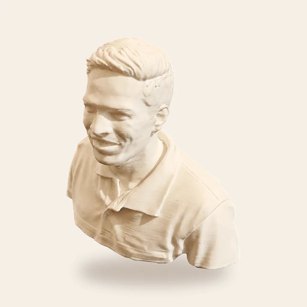 A detailed, likeness-focused portrait sculpture with a quiet sense of presence.
